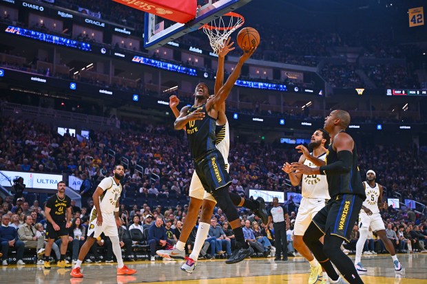 Golden State Warriors' Jimmy Butler III (10) goes up for a basket past Indiana Pacers' Tony Bradley (13) in the first quarter of their NBA game at Chase Center in San Francisco, Calif., on Sunday, Nov. 9, 2025. (Jose Carlos Fajardo/Bay Area News Group)