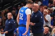 Dallas Mavericks head coach Jason Kidd, right, talks to forward Cooper Flagg (32) during the...