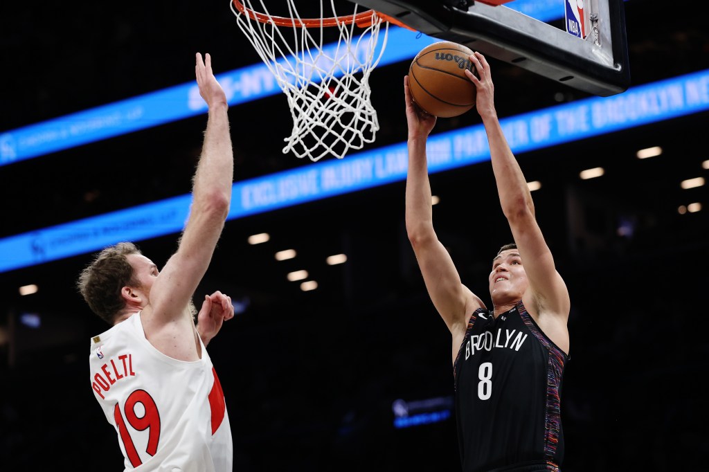 Egor Dëmin goes up for a dunk as Jakob Poeltl defends during the Nets' loss to the Raptors on Nov. 11, 2025.