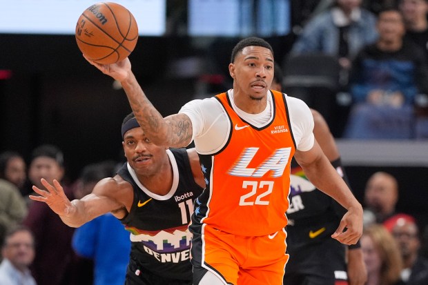 Clippers guard Jordan Miller, right, passes the ball while under...