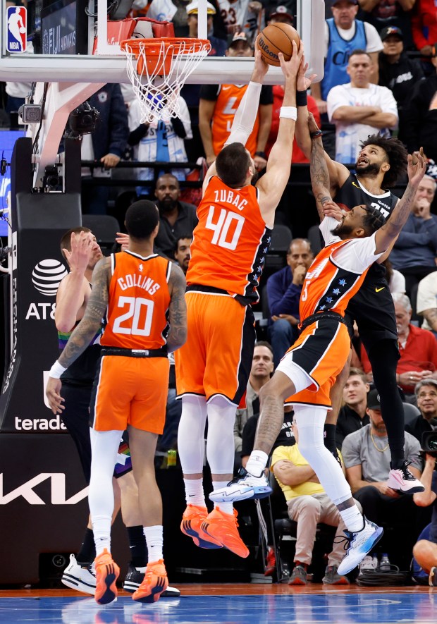 Denver Nuggets guard Jamal Murray, top right, attempts a shot...
