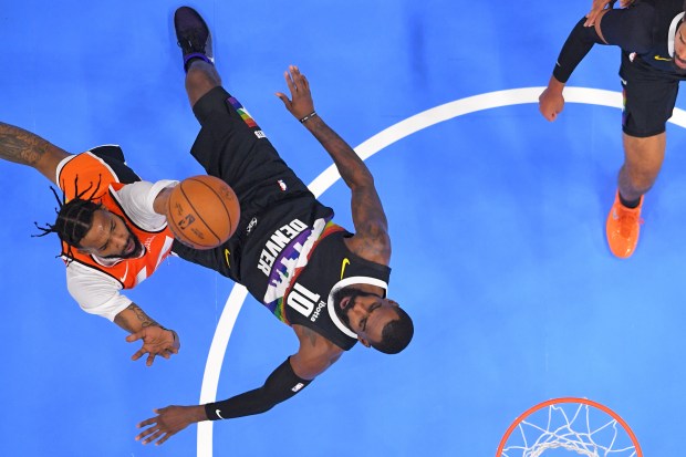 Clippers forward Derrick Jones Jr., left, shoots as Denver Nuggets...