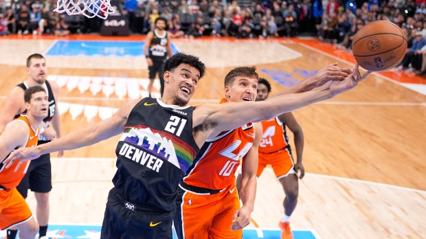 Denver Nuggets forward Spencer Jones, left, and Clippers guard Bogdan...