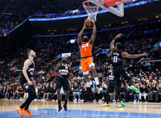 Clippers guard James Harden gets to the basket for a...