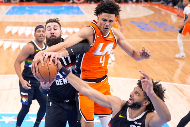 Clippers guard Kobe Sanders, second from right, goes after a...