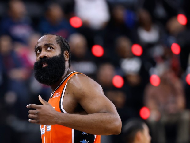 Clippers guard James Harden looks up at the scoreboard after...