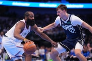 Los Angeles Clippers guard James Harden, left, works the floor against Dallas Mavericks...