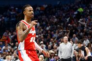 Memphis Grizzlies guard Ja Morant (12) reacts after making a basket over Dallas Mavericks...