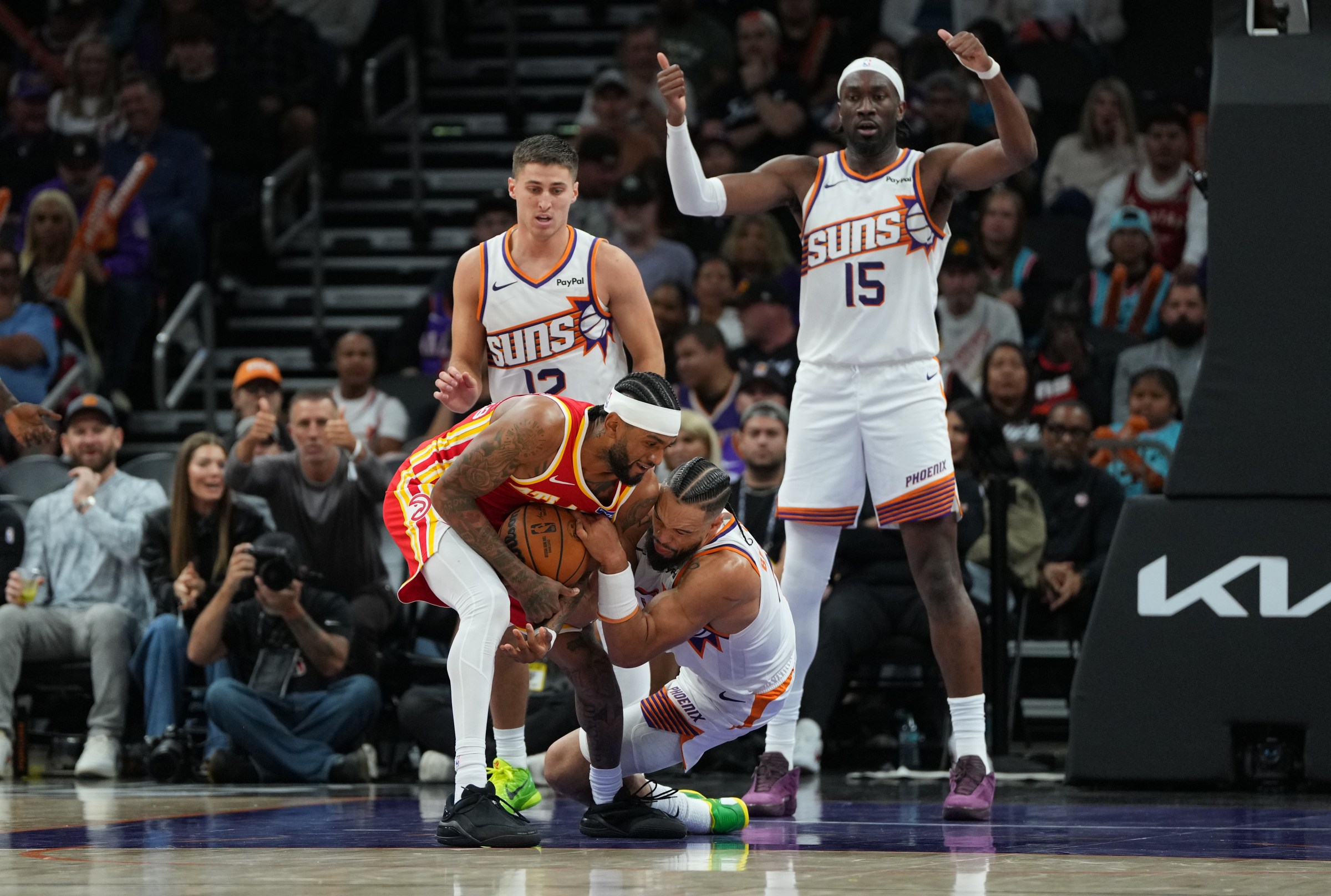 PHOENIX, ARIZONA - NOVEMBER 16: Nickeil Alexander-Walker #7 of the Atlanta Hawks and Dillon Brooks #3 of the Phoenix Suns battle for the ball during the second half at Mortgage Matchup Center on November 16, 2025 in Phoenix, Arizona. NOTE TO USER: User expressly acknowledges and agrees that, by downloading and or using this photograph, User is consenting to the terms and conditions of the Getty Images License Agreement. (Photo by Kelsey Grant/Getty Images)
