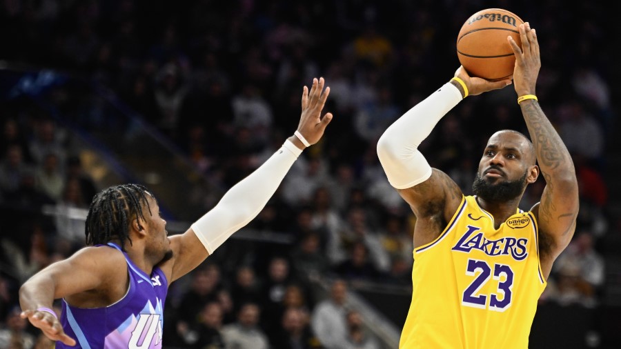 LeBron James #23 of the Los Angeles Lakers shoots over Isaiah Collier #13 of the Utah Jazz...
