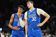 Dallas Mavericks guard Max Christie (00) and forward Cooper Flagg (32) stand together during...