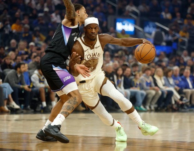 Golden State Warriors' Jimmy Butler (10) dribbles against Utah Jazz's Keyonte George (3) in the first quarter at the Chase Center in San Francisco, Calif., on Monday, Nov. 24, 2025. (Nhat V. Meyer/Bay Area News Group)