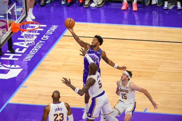 Utah Jazz forward Brice Sensabaugh, top, looks to lay the...
