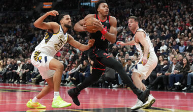 Toronto Raptors forward Scottie Barnes (4) drives to the net between Indiana Pacers forward Jeremiah Robinson-Earl (25) and guard T.J. McConnell (9) during first half NBA Cup basketball action in Toronto on Wednesday, Nov. 26, 2025. (Chris Young/The Canadian Press via AP)