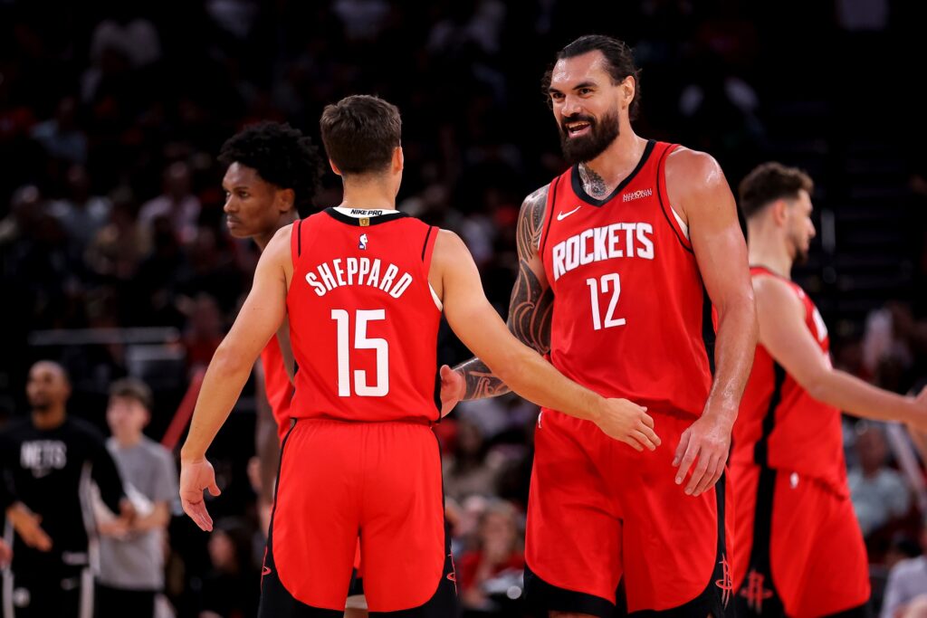 Oct 27, 2025; Houston, Texas, USA; Houston Rockets center Steven Adams (12) talks with Houston Rockets guard Reed Sheppard (15) after the first quarter against the Brooklyn Nets at Toyota Center. Mandatory Credit: Erik Williams-Imagn Images