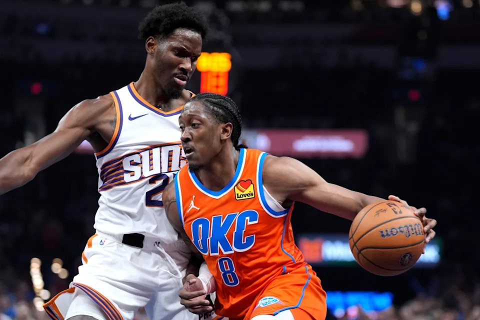 Oklahoma City Thunder guard Jalen Williams (8) dribbles beside Phoenix Suns forward Nigel Hayes-Davis (21) during an NBA Cup basketball game between the Oklahoma City Thunder and the Phoenix Suns at Paycom Center in Oklahoma City, Friday, Nov. 28, 2025.