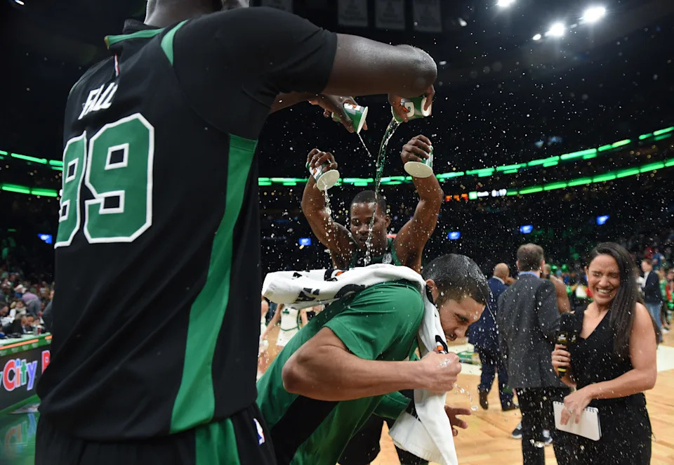 Dec 22, 2019; Boston, Massachusetts, USA; Boston Celtics center Tacko Fall (99) and guard Javonte Green (43) pour water on forward Jayson Tatum (0) after defeating the Charlotte Hornets at TD Garden. Mandatory Credit: Bob DeChiara-USA TODAY Sports