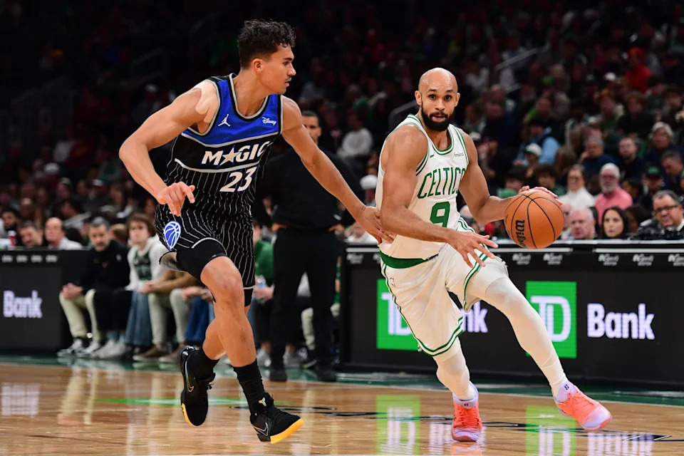 Nov 23, 2025; Boston, Massachusetts, USA; Boston Celtics guard Derrick White (9) controls the ball while Orlando Magic forward Tristan da Silva (23) defends during the second half at TD Garden. Mandatory Credit: Bob DeChiara-Imagn Images