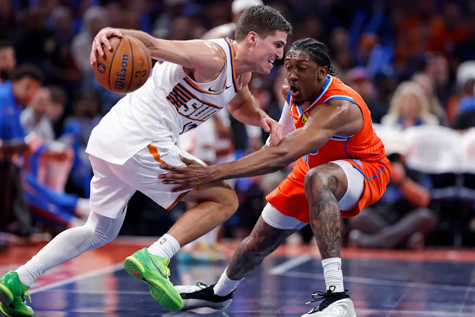 Nov 28, 2025; Oklahoma City, Oklahoma, USA; Phoenix Suns guard Collin Gillespie (12) moves the ball as Oklahoma City Thunder guard Jalen Williams (8) defends during the second half at Paycom Center. Mandatory Credit: Alonzo Adams-Imagn Images