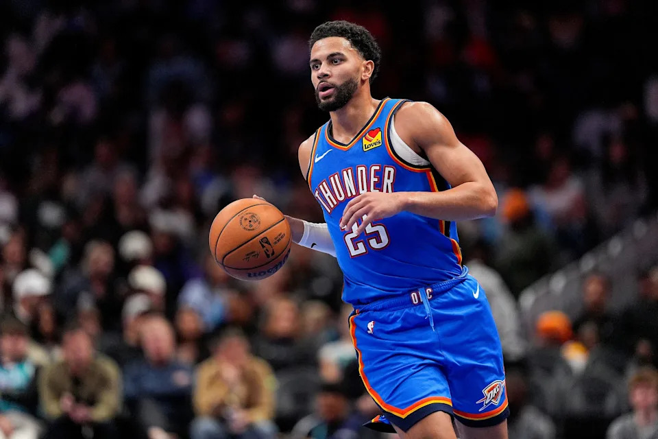 Nov 15, 2025; Charlotte, North Carolina, USA; Oklahoma City Thunder guard Ajay Mitchell (25) brings the ball up court against the Charlotte Hornets during the second half at Spectrum Center. Mandatory Credit: Jim Dedmon-Imagn Images
