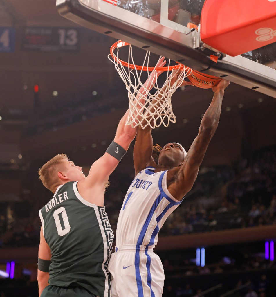 Michigan State Spartans forward Jaxon Kohler (0) stops Kentucky Wildcats guard Denzel Aberdeen (1) at the basket during the first half when the Kentucky Wildcats played the Michigan State Spartans as part of the State Farm Champions Classic Tuesday, November 18, 2025.