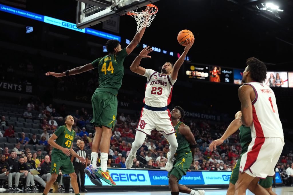 St. John's Red Storm forward Bryce Hopkins (23) goes for a layup against Baylor Bears center Caden Powell (44) in a 2025 Players Era Festival group play game at Michelob Ultra Arena. 