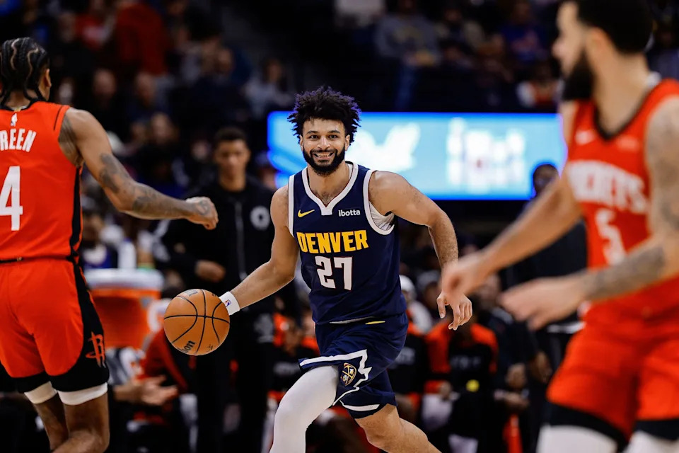 Jan 15, 2025; Denver, Colorado, USA; Denver Nuggets guard Jamal Murray (27) dribbles the ball up court against Houston Rockets guard Fred VanVleet (5) and guard Fred VanVleet (5) in the third quarter at Ball Arena. Mandatory Credit: Isaiah J. Downing-Imagn Images