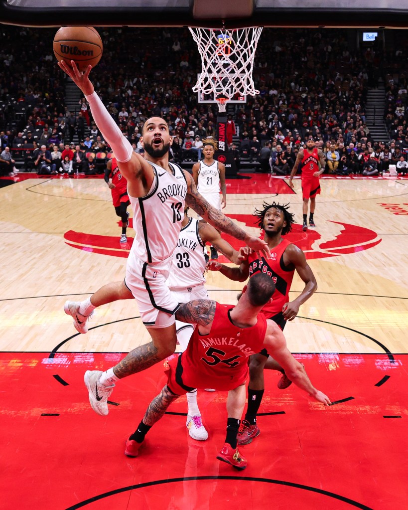 Tyrese Martin drives to the basket for the Nets against the Raptors.