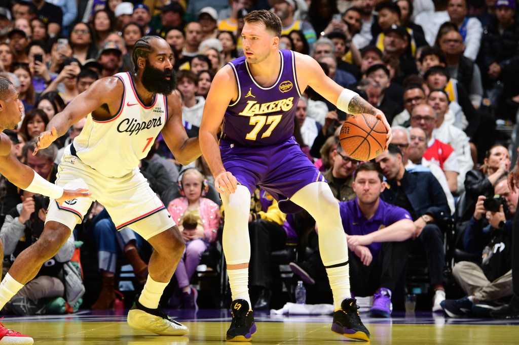 Basketball players from the Los Angeles Clippers and Los Angeles Lakers compete for the ball.