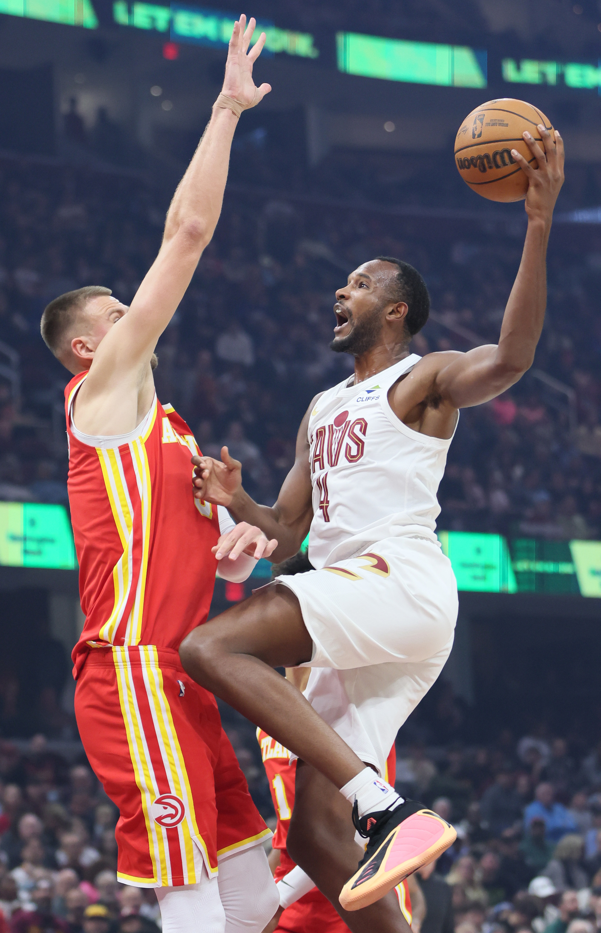 Cleveland Cavaliers center Evan Mobley drives to the basket guarded by Atlanta Hawks center Kristaps Porzingis in the first half at Rocket Arena. 