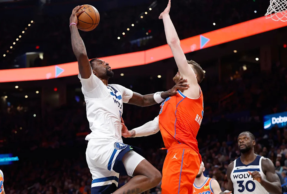Nov 26, 2025; Oklahoma City, Oklahoma, USA; Minnesota Timberwolves center Naz Reid (11) goes to the basket as Oklahoma City Thunder center Isaiah Hartenstein (55) defends during the second half at Paycom Center. Mandatory Credit: Alonzo Adams-Imagn Images