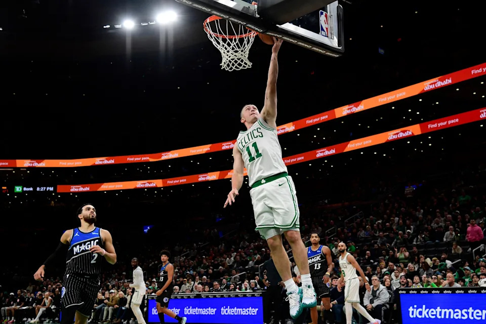 Nov 23, 2025; Boston, Massachusetts, USA; Boston Celtics guard Payton Pritchard (11) lays the ball in the basket during the second half against the Orlando Magic at TD Garden. Mandatory Credit: Bob DeChiara-Imagn Images