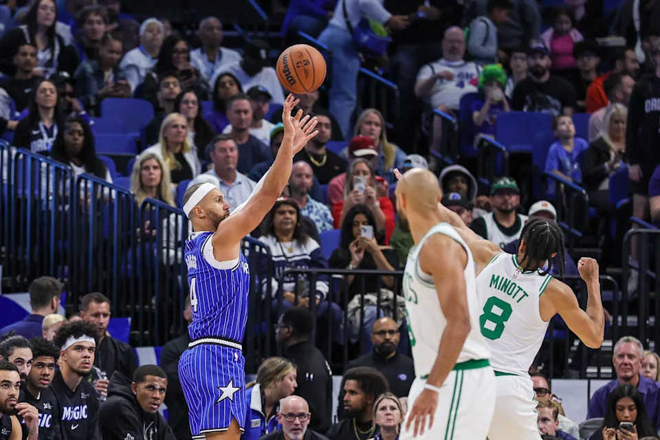 Nov 9, 2025; Orlando, Florida, USA; Orlando Magic guard Jalen Suggs (4) shoots over Boston Celtics forward Josh Minott (8) during the first quarter at Kia Center. Mandatory Credit: Mike Watters-Imagn Images