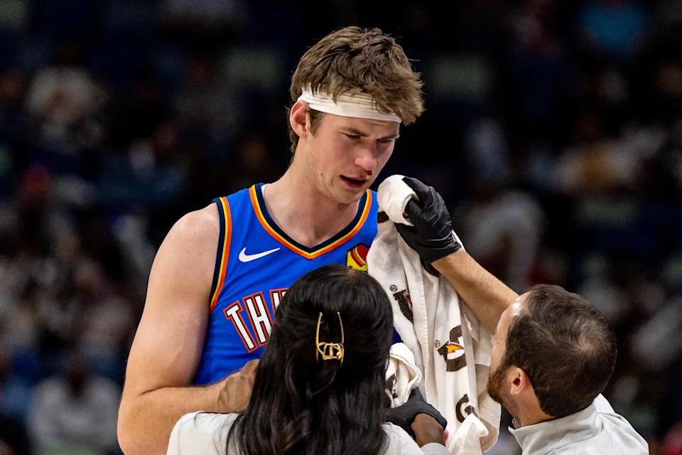Nov 17, 2025; New Orleans, Louisiana, USA; Oklahoma City Thunder center Branden Carlson (15) seeks medical attention for a bloody nose after a play against the New Orleans Pelicans during the second half at Smoothie King Center. Mandatory Credit: Stephen Lew-Imagn Images