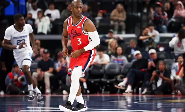 Los Angeles Clippers guard Chris Paul (3) reacts after making a 3-point basket as Memphis Grizzlies forward Cedric Coward, back left, runs during the first half of an NBA Cup basketball game Friday, Nov. 28, 2025, in Inglewood, Calif. (AP Photo/Jessie Alcheh)