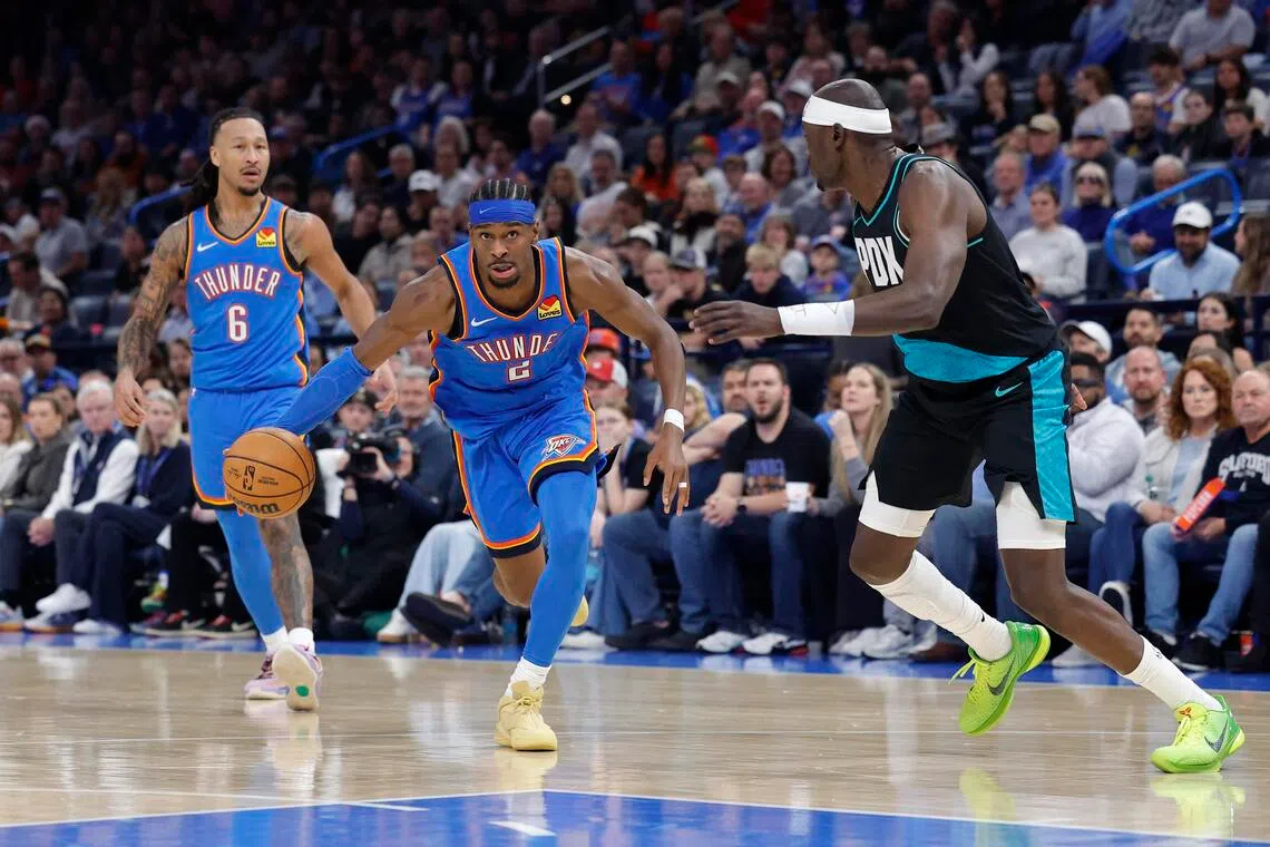 Oklahoma City Thunder guard Shai Gilgeous-Alexander drives past Portland Trail Blazers center Duop Reath during the second half at Paycom Center.