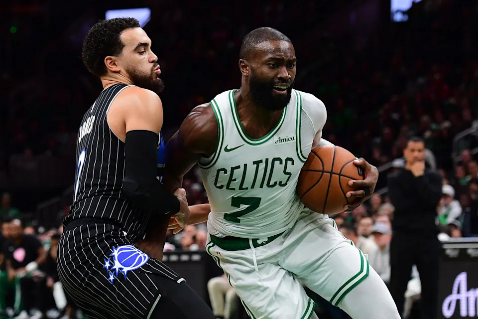 Nov 23, 2025; Boston, Massachusetts, USA; Orlando Magic guard Tyus Jones (2) defends Boston Celtics guard Jaylen Brown (7) during the second half at TD Garden. Mandatory Credit: Bob DeChiara-Imagn Images