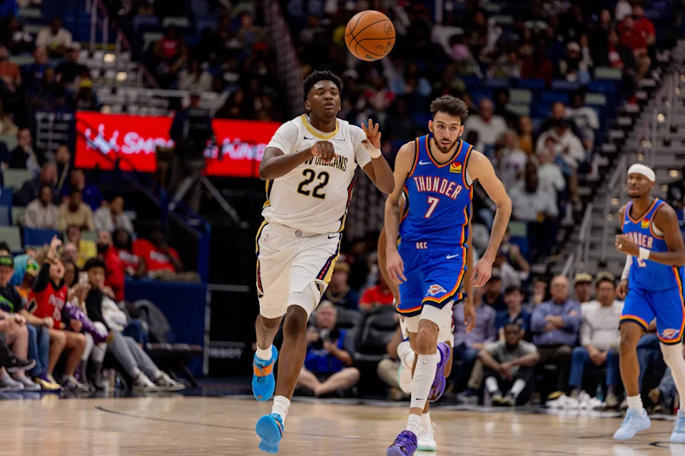 Nov 17, 2025; New Orleans, Louisiana, USA; New Orleans Pelicans center Derik Queen (22) passes the ball against Oklahoma City Thunder center/forward Chet Holmgren (7) during the second half at Smoothie King Center. Mandatory Credit: Stephen Lew-Imagn Images