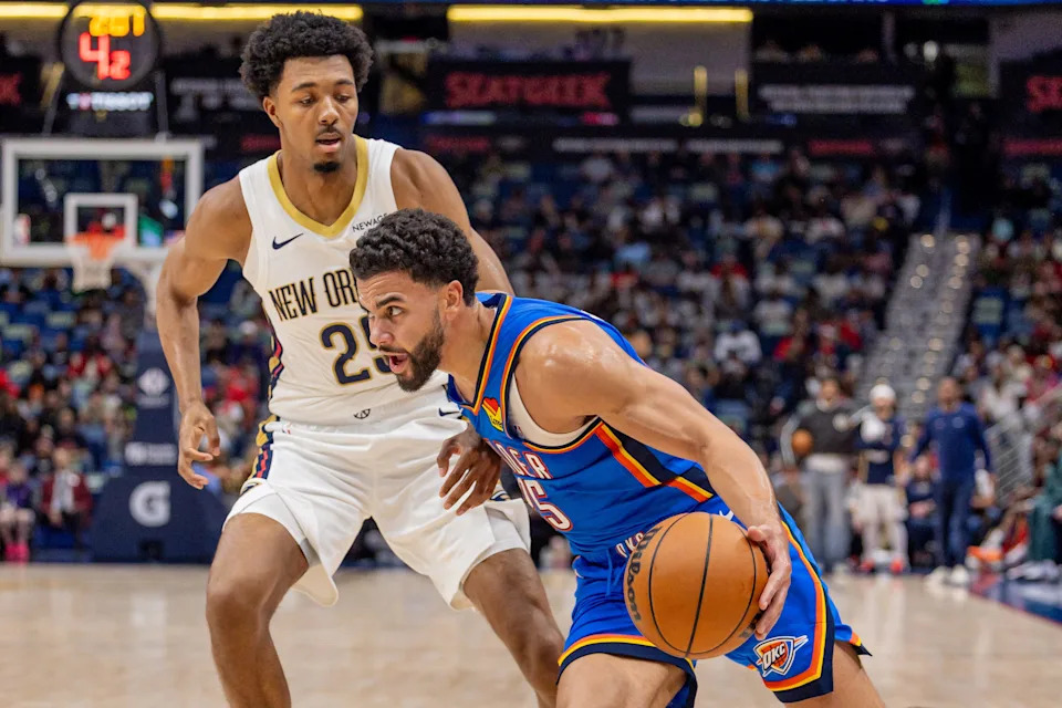 Nov 17, 2025; New Orleans, Louisiana, USA; Oklahoma City Thunder guard Ajay Mitchell (25) dribbles against New Orleans Pelicans forward Trey Murphy III (25) during the first half at Smoothie King Center. Mandatory Credit: Stephen Lew-Imagn Images