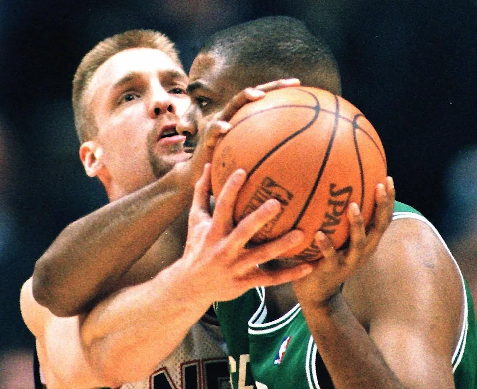 EAST RUTHERFORD, UNITED STATES: Boston Celtics center Eric Riley (R) tries to keep the ball away from New Jersey Nets center Jim McIlvaine (L) in the second quarter 27 February at Continental Airlines Arena in East Rutherford, NJ.  AFP PHOTO/Matt CAMPBELL (Photo credit should read MATT CAMPBELL/AFP via Getty Images)