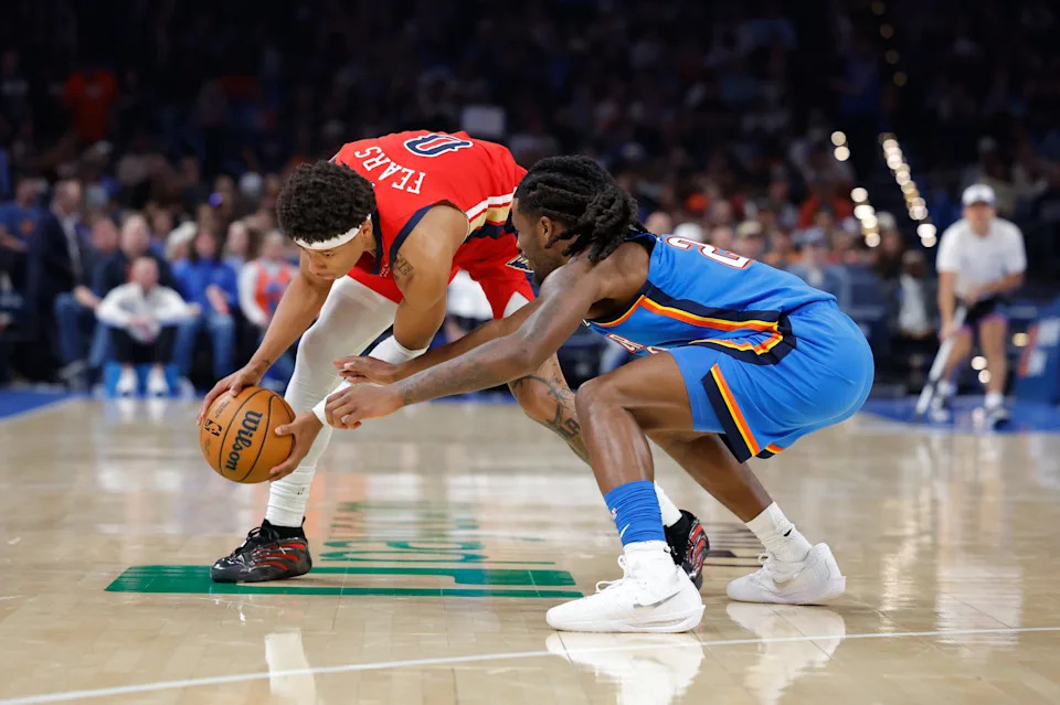 Nov 2, 2025; Oklahoma City, Oklahoma, USA; New Orleans Pelicans guard Jeremiah Fears (0) works to control the ball as Oklahoma City Thunder guard Cason Wallace (22) attempts to steal during the second half at Paycom Center. Mandatory Credit: Alonzo Adams-Imagn Images