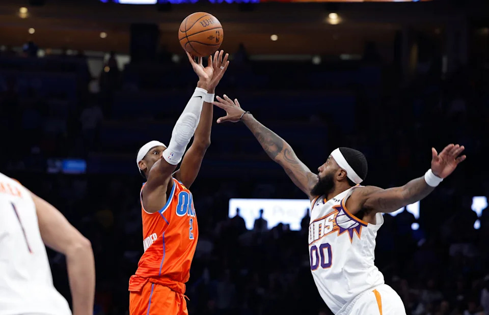 Nov 28, 2025; Oklahoma City, Oklahoma, USA; Oklahoma City Thunder guard Shai Gilgeous-Alexander (2) shoots over Phoenix Suns forward Royce O'Neale (00) during the second half at Paycom Center. Mandatory Credit: Alonzo Adams-Imagn Images