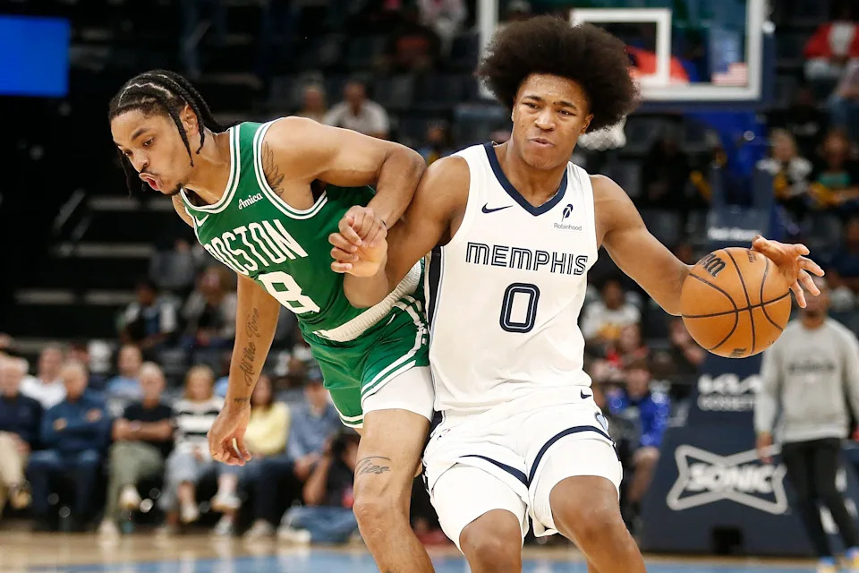 Oct 8, 2025; Memphis, Tennessee, USA; Memphis Grizzlies forward Jaylen Wells (0) dribbles as Boston Celtics forward Josh Minott (8) defends during the third quarter at FedExForum. Mandatory Credit: Petre Thomas-Imagn Images