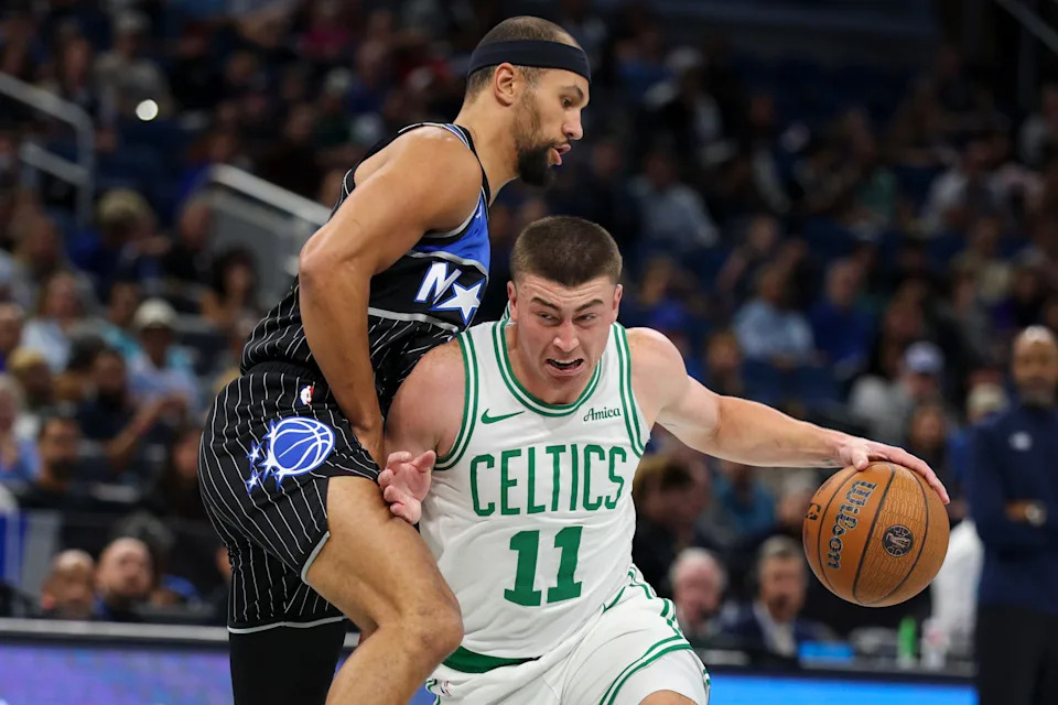 Nov 7, 2025; Orlando, Florida, USA; Boston Celtics guard Payton Pritchard (11) drives to the basket past Orlando Magic guard Jalen Suggs (4) in the first quarter at Kia Center. Mandatory Credit: Nathan Ray Seebeck-Imagn Images