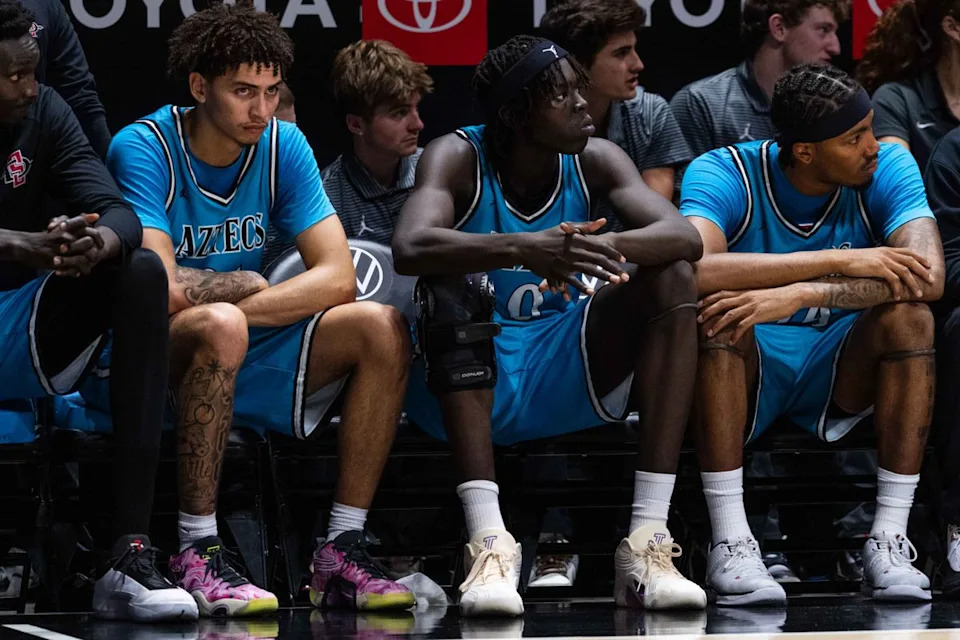 San Diego State players sit on the bench during an NCAA Basketball game against Troy, Tuesday November 18, 2025 at Viejas Arena in San Diego, Calif.