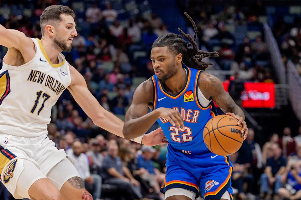Nov 17, 2025; New Orleans, Louisiana, USA; Oklahoma City Thunder guard Cason Wallace (22) dribbles against New Orleans Pelicans forward/center Karlo Matković (17) during the first half at Smoothie King Center. Mandatory Credit: Stephen Lew-Imagn Images