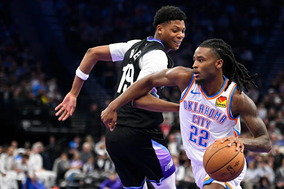 SALT LAKE CITY, UTAH - NOVEMBER 21: Cason Wallace #22 of the Oklahoma City Thunder drives in front of Ace Bailey #19 of the Utah Jazz during the second half of a 2025-26 Emirates Cup game at Delta Center on November 21, 2025 in Salt Lake City, Utah. NOTE TO USER: User expressly acknowledges and agrees that, by downloading and or using this photograph, User is consenting to the terms and conditions of the Getty Images License Agreement. (Photo by Alex Goodlett/Getty Images)