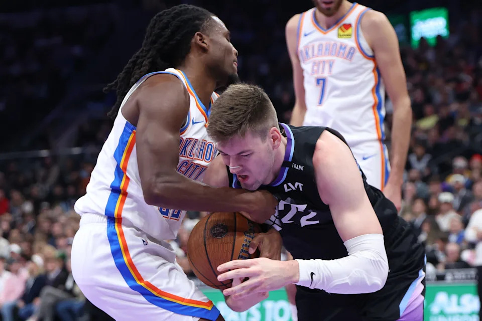 Nov 21, 2025; Salt Lake City, Utah, USA; Oklahoma City Thunder guard Cason Wallace (22) and Utah Jazz forward Kyle Filipowski (22) battle for the ball during the first half at Delta Center. Mandatory Credit: Rob Gray-Imagn Images