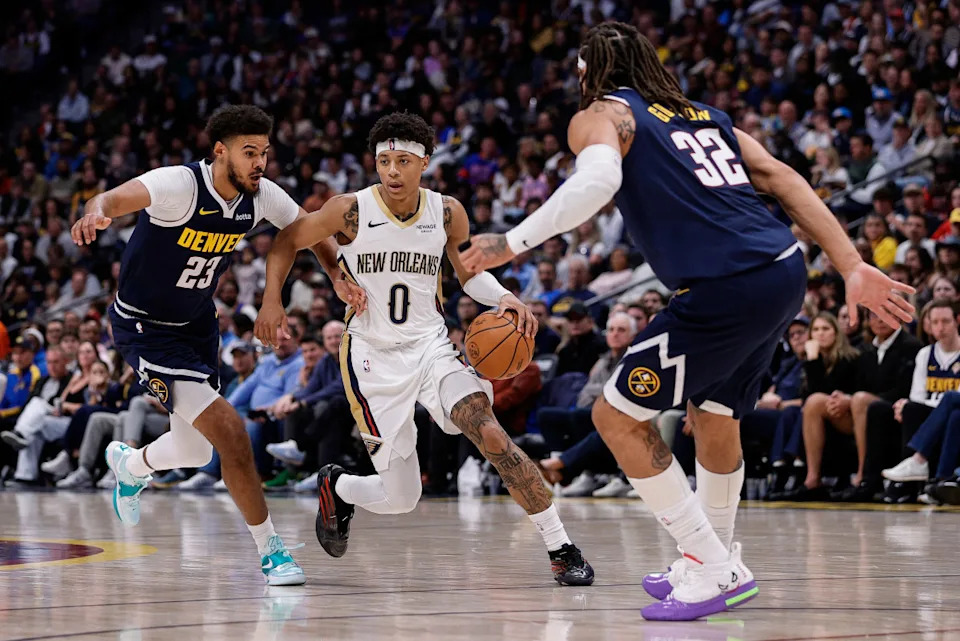 New Orleans Pelicans guard Jeremiah Fears (0) controls the ball under pressure from Denver Nuggets forward Cam Johnson (23) and forward Aaron Gordon (32)Isaiah J&period; Downing-Imagn Images