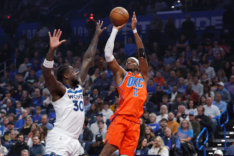 Nov 26, 2025; Oklahoma City, Oklahoma, USA; Oklahoma City Thunder guard Shai Gilgeous-Alexander (2) shoots over Minnesota Timberwolves forward Julius Randle (30) during the first quarter at Paycom Center. Mandatory Credit: Alonzo Adams-Imagn Images